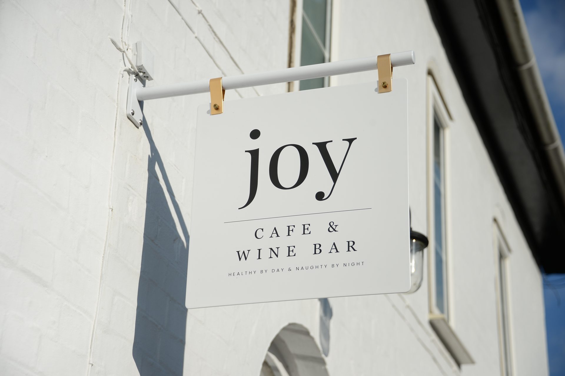 Joy Cafe & Wine Bar sign outside 28 Station Road
